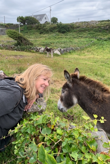 Joan Thompson loves to travel. Here, she's trying to befriend a donkey in Inishmore, Ireland.