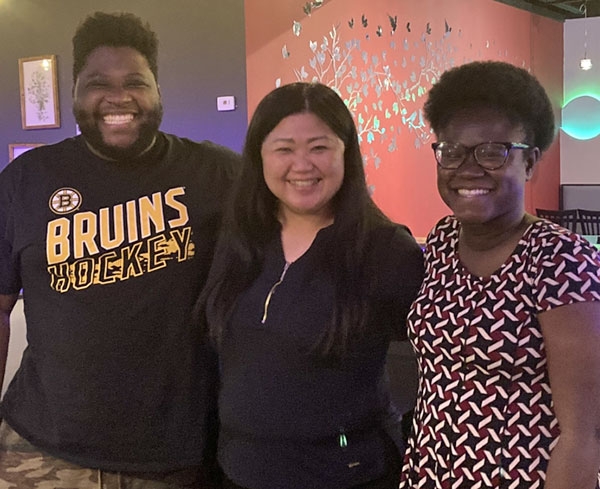 Shou-Ping Liu, center, the Department of Music’s director of performance and a lecturer in choral and orchestral conducting, at a dinner with Posse students.