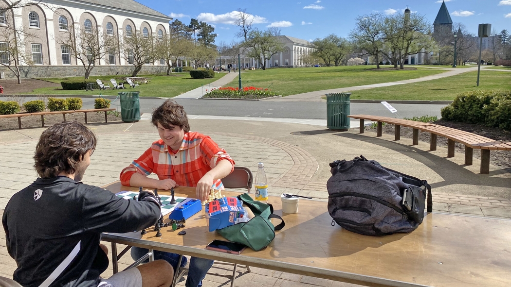 Students playing chess outside