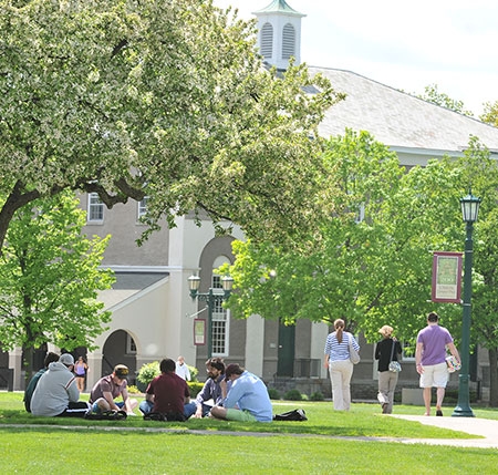 Students sitting on one of the College's lawns.
