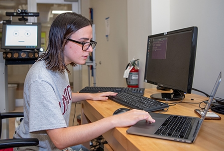Summer research - Daniella Massa ‘23 - student  working at the computer