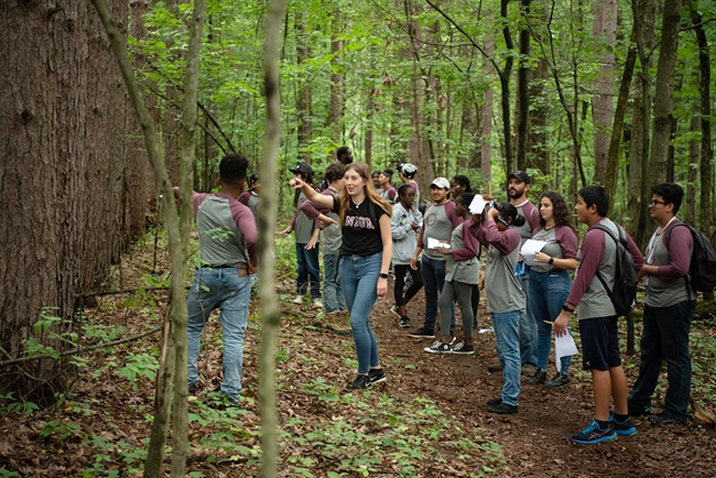 Maeve Daby ’23 leads students in Union’s summer Science and Technology Entry Program (STEP) on a nature walk through the H.G. Reist Sanctuary, a 111-acre preserve that borders the Kelly Adirondack Center.