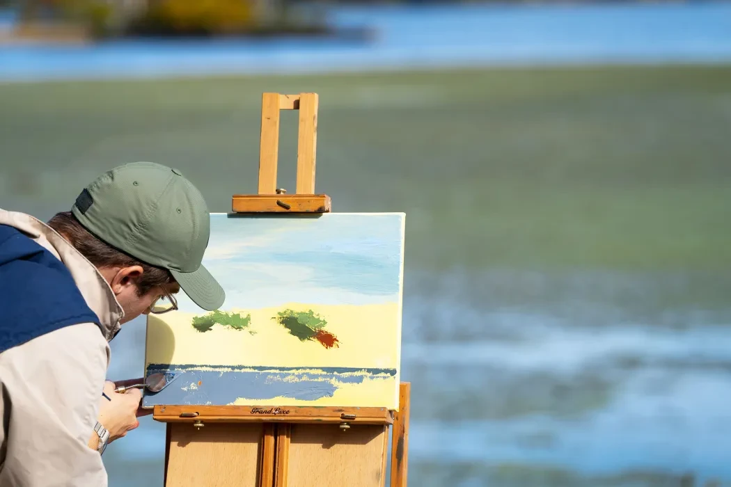 A student paints outdoors 