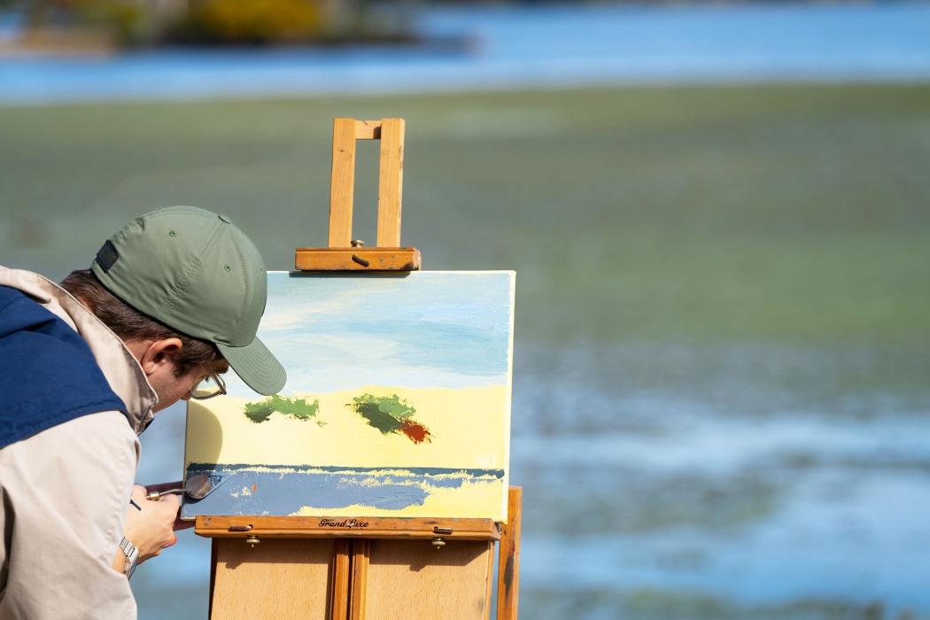 A student paints outdoors 