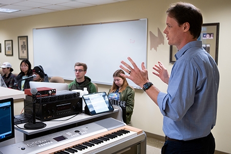 Professor Chandler in a classroom with students.