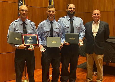 At their recent graduation from the Zone 5 Regional Law Enforcement Training Center program, from left, Officers Peter Parker, Corey Compositor and Adam Blanc are joined by Scott Jones, vice president for administration and finance. Officer Parker graduated as class leader.