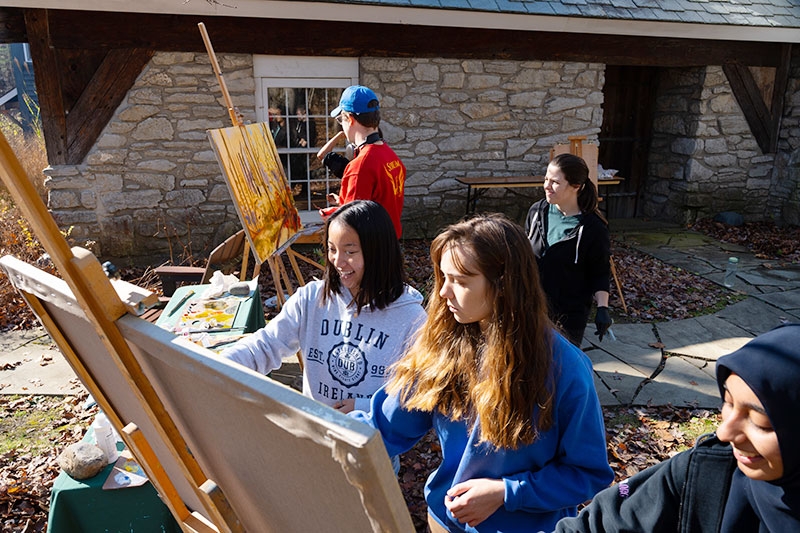 Students show off their paintings