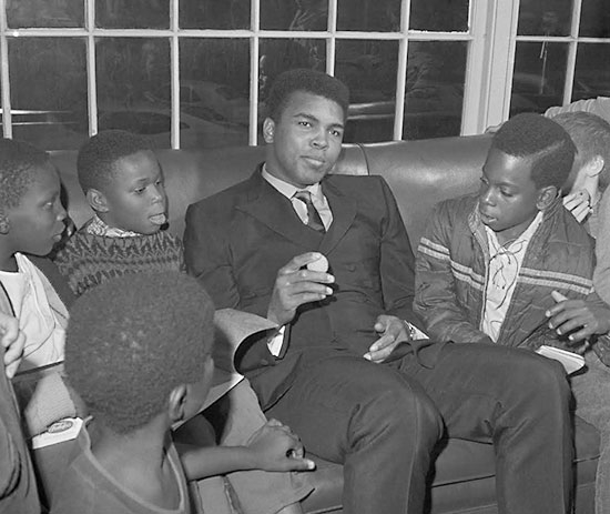 Muhammed Ali jokes with local fourth-graders at Phi Sigma Delta's House.