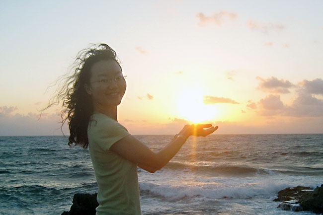 Jue (Joy) Wang enjoys sunrise in Isla Mujeres, where the sun's rays touch Mexico for the first time.