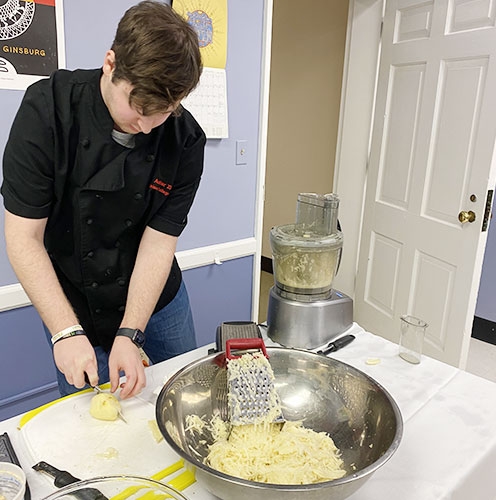 Union student cutting potatoes