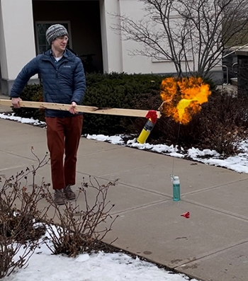 Prof. Brandon Schabes ignites hydrogen balloons in STEP event