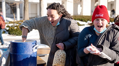 Students enjoying popcorn at Winterfest 2022