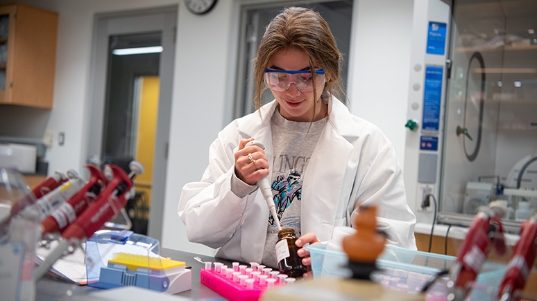 A student conducting student research in one of the chemistry labs