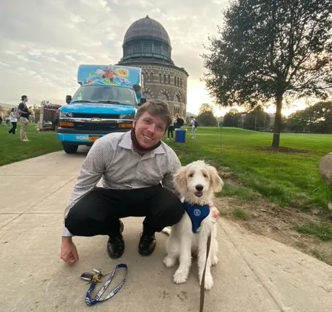 Mark Yetman with a dog in front of the Nott Memorial