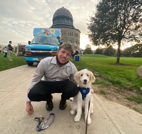 Mark Yetman with a dog in front of the Nott Memorial