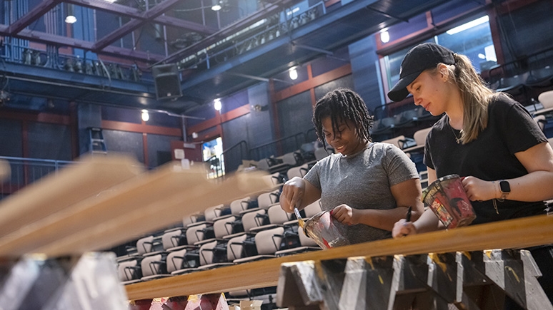 Students painting a Yulman Theater set.