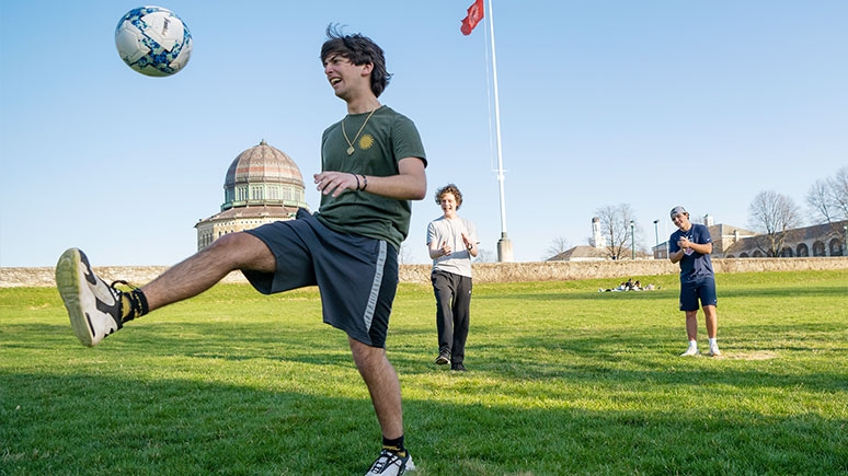 Student kicks a soccer ball