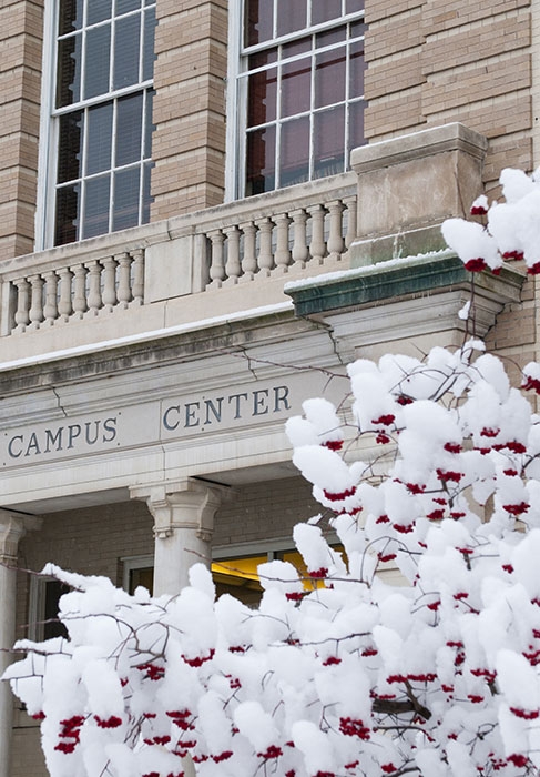 A view of a snow covered tree in front of Reamer Campus Center