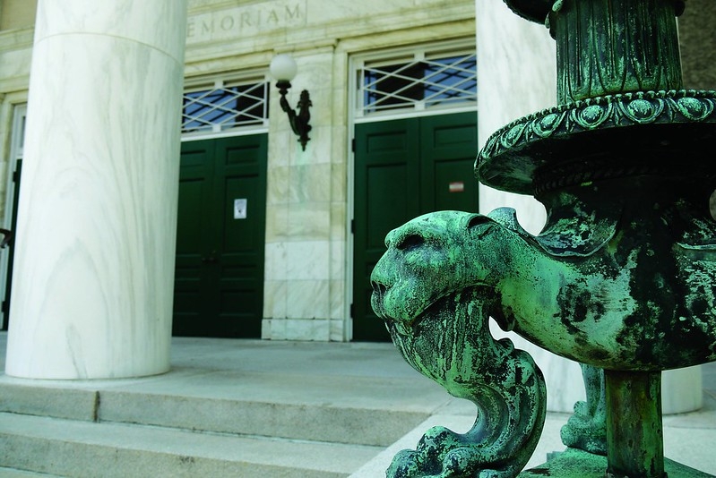A figurative lion in the base of a lamp post stands sentienal at the entrance to Memorial Chapel