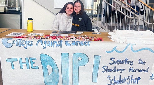 Students at a table promoting the Dip fundraiser