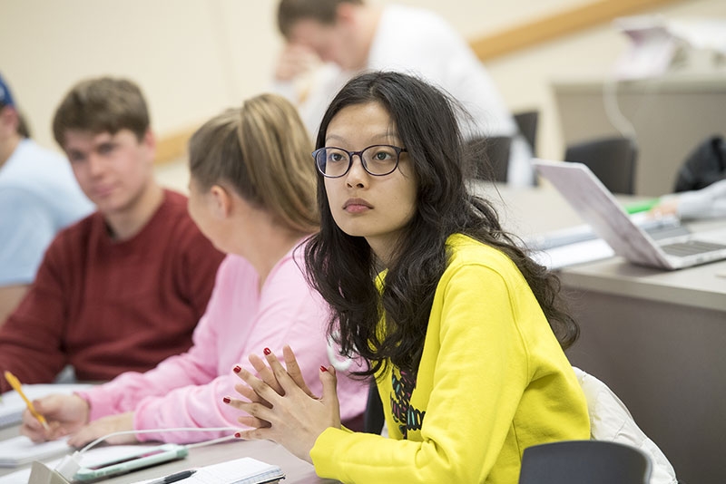 An attentive student listening to an economics lecture in one of the Lippman Hall classrooms.