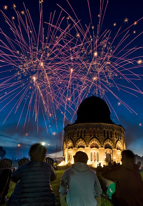 A view of the Nott  silhouetted against the night sky with fireworks 