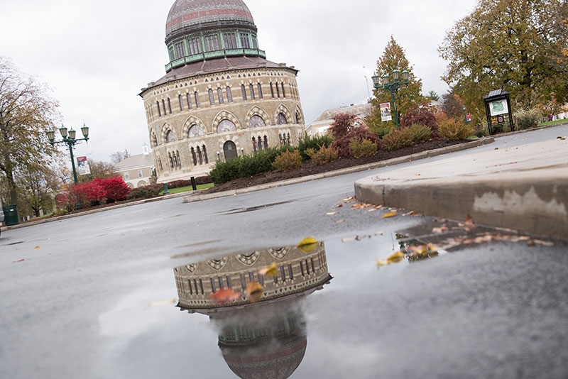 The Nott Memorial is reflected in a puddle