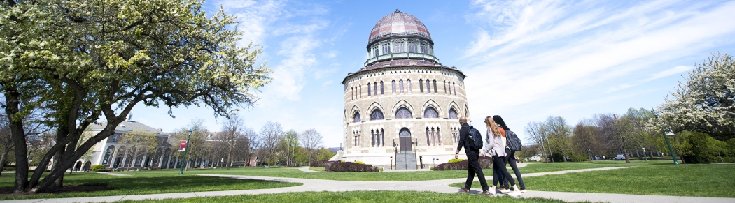 Students walking across campus with the Nott Memorial visible in the background.