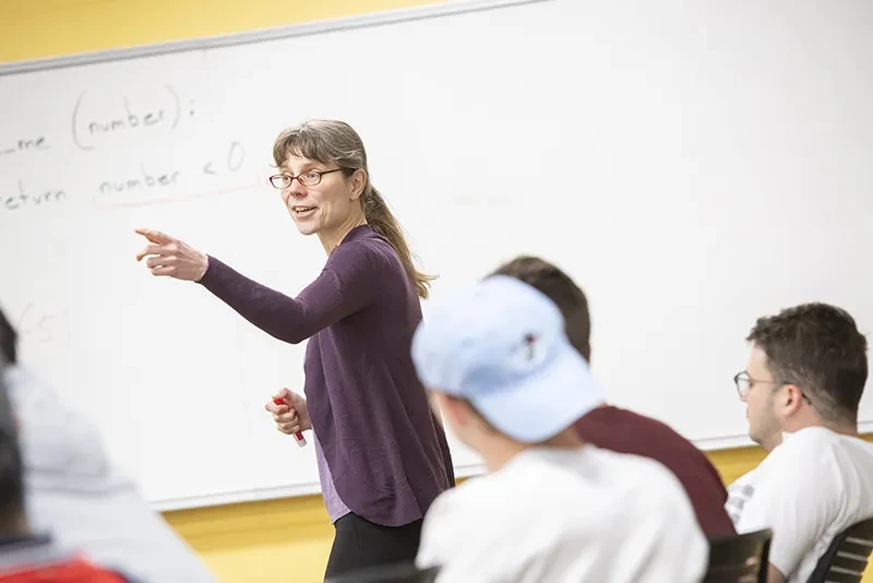 Professor Kristina Striegnitz gestures while teaching a computer science class.