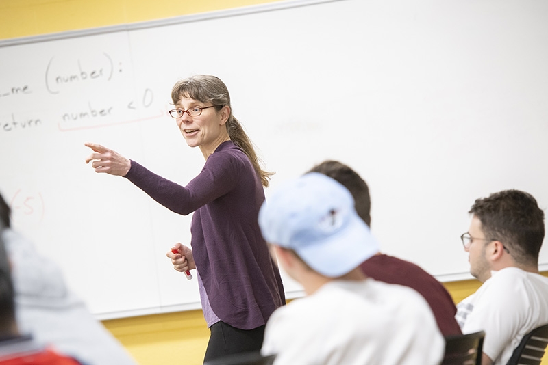 Professor Kristina Striegnitz gestures while teaching a computer science class.
