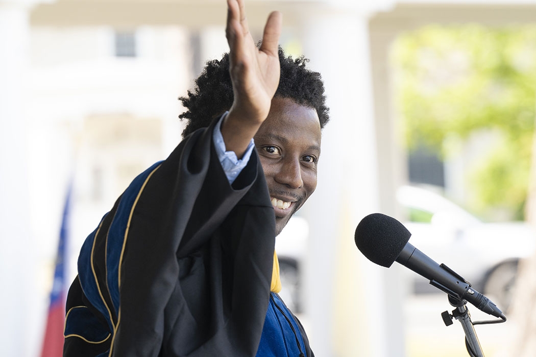 Commencement featured speaker Stanley Andrisse waves at the crowd .