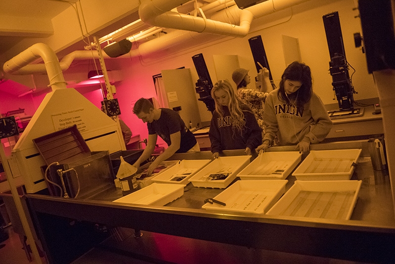 Students develop photos in a darkroom located within the  Feigenbaum Center for Visual Arts.