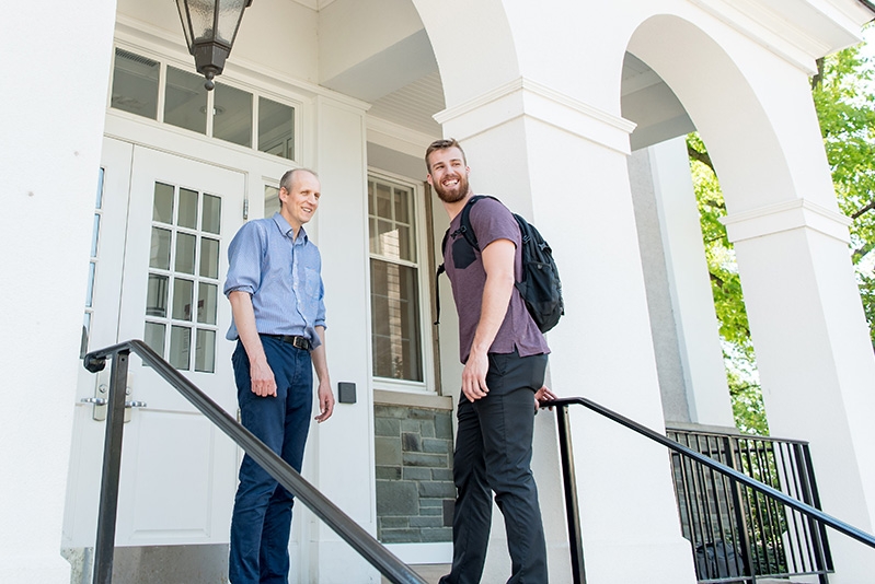 Economics professor Thomas Dvorak speaks with a student outside of Lippman Hall.