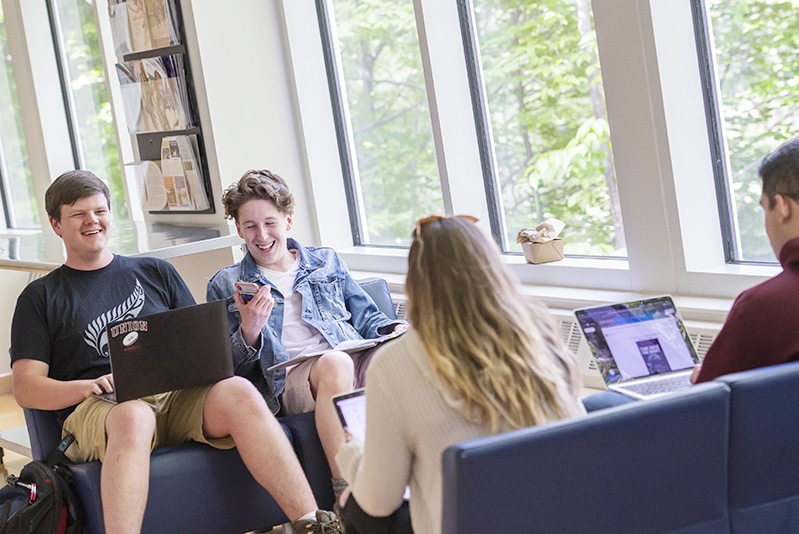 Students sitting and studying in the Henle Dance Pavilion lobby.