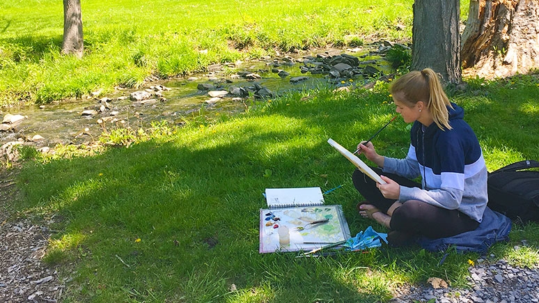 A student painting in Jackson's Garden