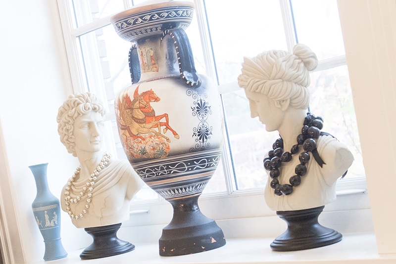 Three classical busts are positioned on a windowsill in Lamont House.