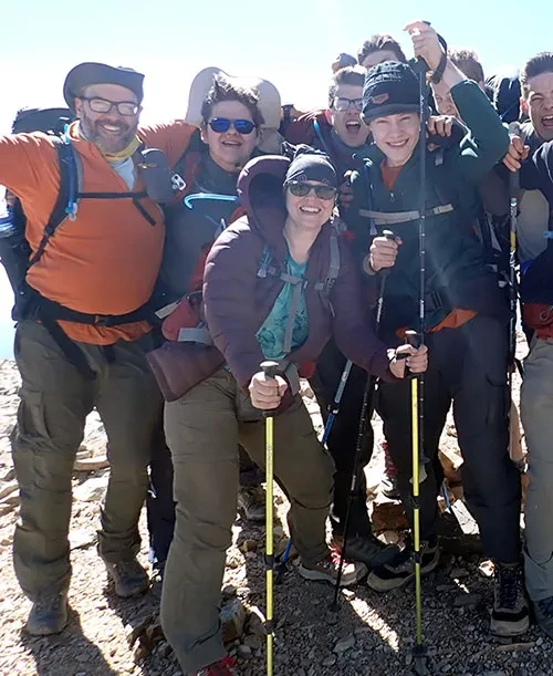 Sara Garrand '97, MAT '00 (with yellow poles) atop&nbsp;Baldy Mountain (12, 441 ft.) in New Mexico's Cimarron Range.