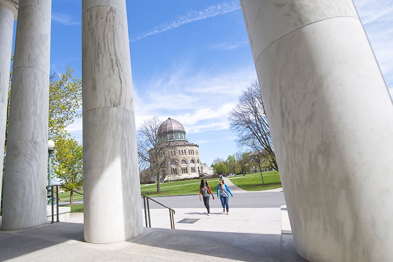 Students approaching Memorial Chapel, featuring its prominent columns in the foreground