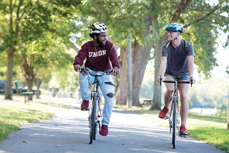 Two students biking along the Mohawk Bike Trail