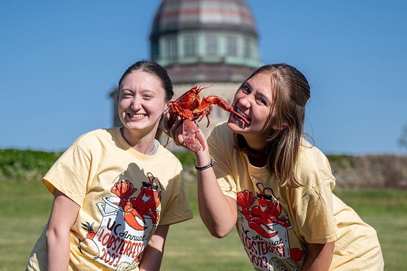 Students enjoying a lobster at the annual Lobsterfest festivities.