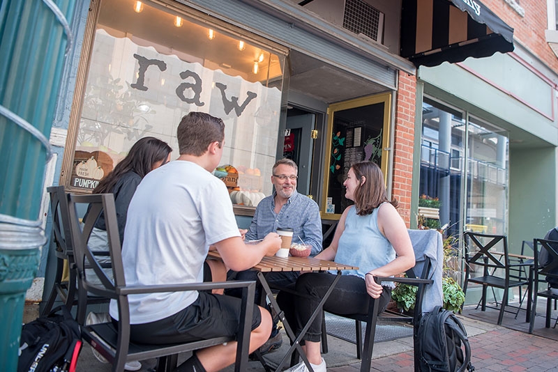 Students eating at an outdoor cafe on Jay Street in Schenectady.