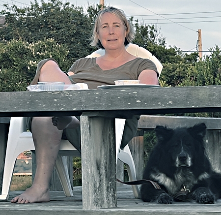 Sara Schmidt, director of Special Collections and Archives at Schaffer Library, and Finn, her 13-year-old mutt, relax last summer on Madaket Beach on Nantucket Island