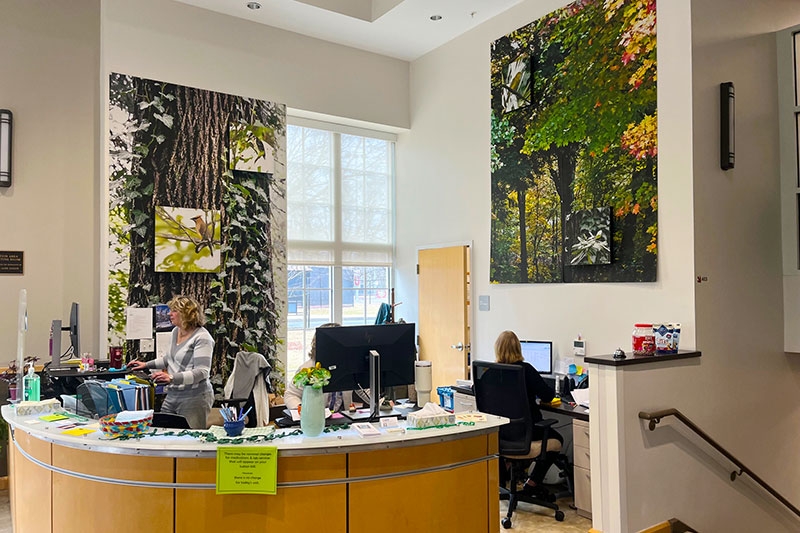  A perspective of the Wicker Wellness Center lobby, featuring the visible front desk with staff positioned behind it.