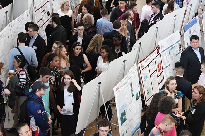 Students gather in the Wold Center Atrium for the Steinmetz Symposium poster session