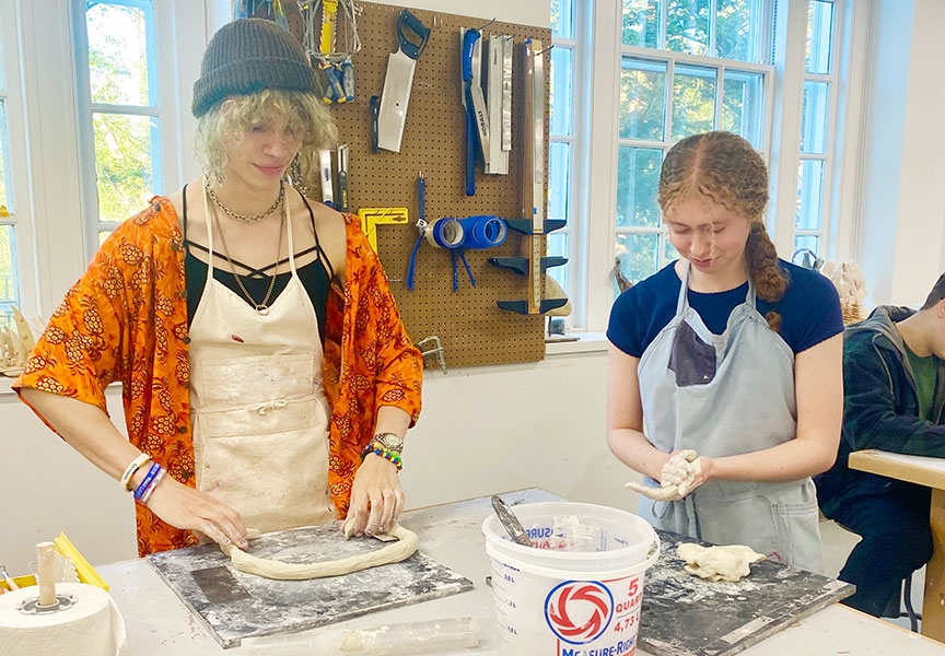 Two students working in clay in one of the studios