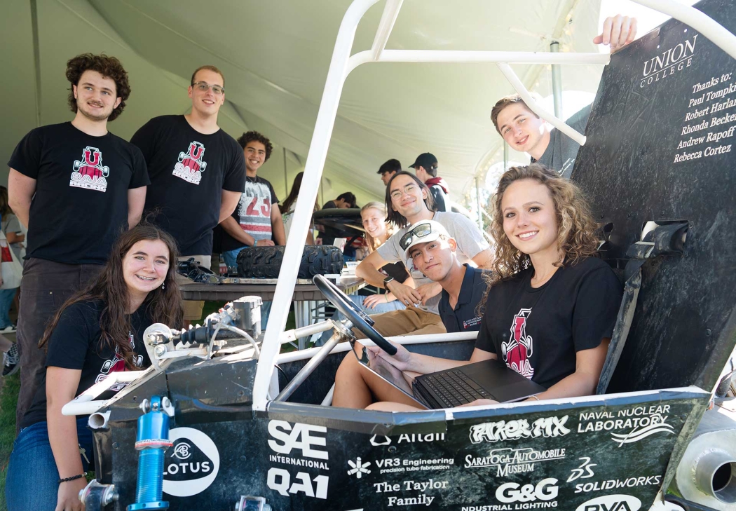 Students in the baja club pose with one of the cars