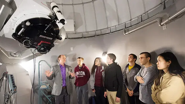 An astronomy professor explains the workings of a 20-inch Ritchey-Chretien telescope to Union students.