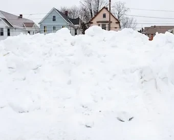Snow cleared from campus is eventually transported and dumped in a pile by Fero House.