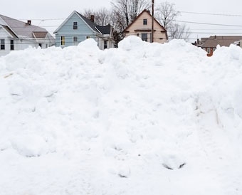 Snow cleared from campus is eventually transported and dumped in a pile by Fero House.