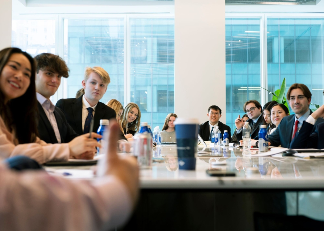 Students sitting around a conference table at Finance bootcamp in NYC